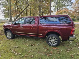 side view of red truck with topper